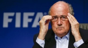 FIFA President Sepp Blatter adjusts his glasses as he addresses a news conference