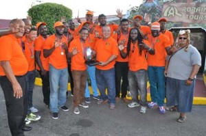 President of the Union Peter Green (centre) holds the NACRA Trophy along with Leon Greaves yesterday at the Cheddi Jagan International Airport.