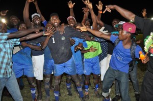  Golden Hands! Ann’s Grove substitute goalkeeper Jamal Blair is congratulated by teammates and supporter’s following his two saves against Cougars that brought them victory. 