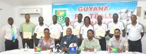 The recently accredited referees (standing) display their certificates with members of the Normalisation Committee.