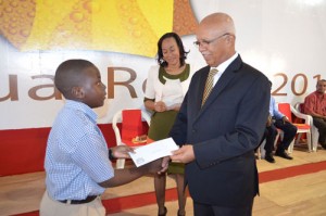 A student receives a cheque  from Chairman/Managing  Director Clifford Reis