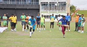 Devendra Bishoo (left) and Amir Khan going through their paces in the runner three while other members await their turn. 