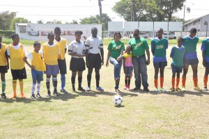 Nestle Milo representative Renita Sital (centre) kicks off the ball to signal the start of competition in this year’s event.