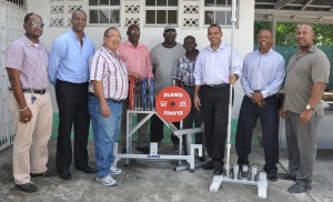 - Minister of Culture, Youth and Sport Dr. Frank Anthony (3rd right) and President of GAPF Peter Green (3rd left) display some of the equipment with officials from both entities. 