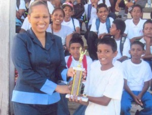 GT&T Representative, Ms Lisa Mc Lean hands over the Man-of-the-Finals trophy to Harrinarine Adolphus