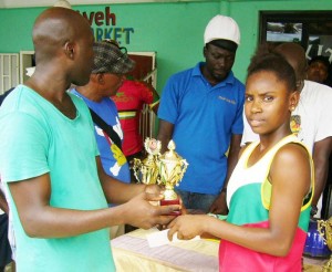 Melissa Kyte receives her trophy and cash from one of the sponsors.