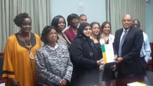 RCC Chairperson Aleema Nasir handing over 2012 repot to Speaker of the National Assembly, Raphael Trotman (forefront) with members of civil society.