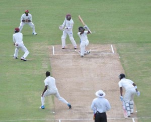 Rajendra Chandrika launches into a big drive off Hayden Walsh yesterday.