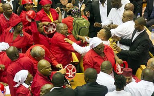 Members of Julius Malema’s Economic Freedom Fighters (EFF) (in red) clash with security officials after being ordered out of the chamber during President Jacob Zuma’s State of the Nation address in Cape Town, South Africa. Photo: REUTERS