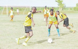 Action in the clash between St. George’s and Brickdam Secondary in yesterday’s fixtures of the Nestle Milo Under-20 Schools Football Competition.