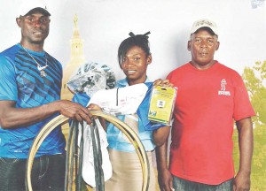 Flashback: Wilbert Benjamin (left) presenting items to Marica Dick with Randolph Roberts in attendance.