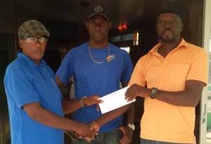 Sponsor Sha’veh (right) of the Shaveh restaurant hands over the cheque to organiser Randolph Roberts of the FACC. Former national cyclist and co-sponsor Wilbert Benjamin looks on.  