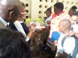 Minister Manickchand in the company of others after the unveiling of the school’s dedication plaque