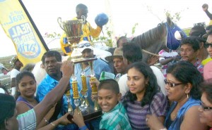  In celebratory mood as a representative of the Peter Lewis and Sons Construction Company presents the beautiful trophy to the Simple Royal Stable.