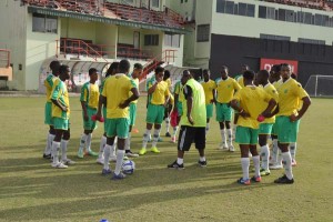 Golden Jaguar Captain Christopher Nurse (right) and colleagues listens to Head Coach Jamaal Shabazz during yesterday’s session at eth Guyana National Stadium, Providence. 