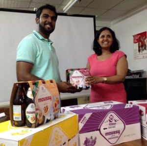 CEO of Southland International Mr Irzad Zamal handing over the Moussy beverage to Programme Manager of NAPS Dr Shanti Singh.