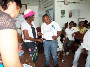 One of the graduates receiving his certificate in block making and block-laying.