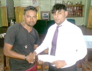 Shabeer Baksh receives cheque from Arnand Kistoo, a friend of the sponsor.