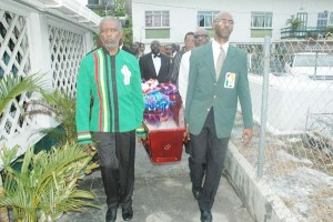 GOA’s Charles Corbin (left), Garfield Wiltshire, Ivor O’Brien and Noel Adonis (in that order, right) among others, including brother, Anthony Blackmore, bear the casket, including the body of the late Shanomae Blackmore yesterday on the way to burial in the St. James-the-Less Parish Cemetery.