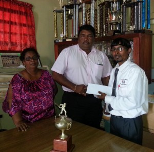 Surendra Shivrattan, a local representative of Mukesh Appiah presents sponsorship cheque to President of BCB, Anil Beharry (centre) in the presence of board secretary Angela Haniff.