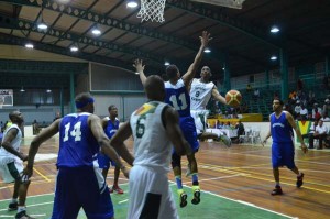 Travis Burnett (airborne, with ball), making his national senior debut, mesmerises defenders in the paint on his way to finishing a left-handed lay-up.