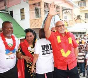 President Ramotar waves to the crowd while outgoing  Prime Minister Samuel Hinds and his wife are greeted by First Lady Deolatchmie Ramotar (backing)