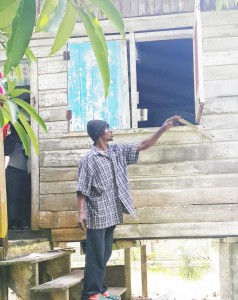 One of Giles’ siblings pointing at the window where his brother was shot