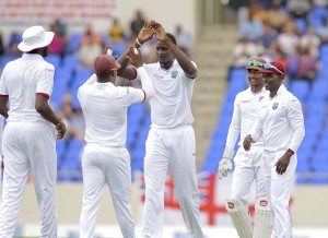 Jason Holder high fives Darren Bravo