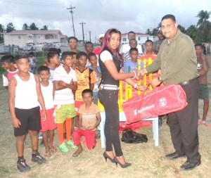 President of EBDCA, Anand Kalladeen handing over the kits to Overseer of the Little Diamond/Herstelling NDC, Diane Barath.