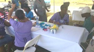 Persons having their blood pressure and blood sugar tests done.