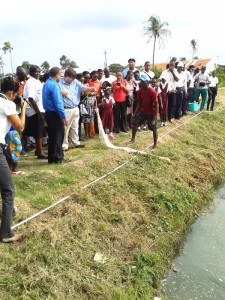 Charge D Affairs Brian Hunte pulling up his catch of Red Tilapia.