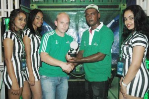 Heineken Brand Manager, Robert Hiscock (third, left) presents a Heineken UEFA branded wrist watch to Bobby Harrilall along with the Heineken models Saturday night at Jameel’s Bar, Public Road, Atlantic Gardens.  