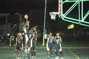  CLEAR THE PAINT! Guardians forward, Mark Richards elevates between three UG defenders in the paint for a right-handed floater Wednesday night on Burnham Basketball Court.