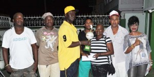 Captain of Saddam team Jillian Hyman (right) accepts the team prizes from Frank Small. 