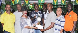 President of the GDA Faye Joseph presents the trophy and cash prize to vice captain of Thunder, Kevin Boston in the presence of other members. At right is Organising Secretary of the GDA Mark Wiltshire.