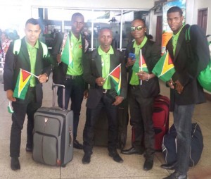 Smartly dressed in black tunics, the boxers display miniature flags just before boarding their flight at the Cheddie Jagan International Airport, Timerhi.