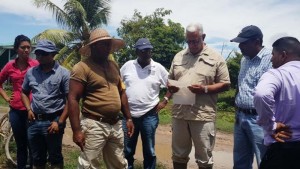 Agriculture Minister Noel Holder (3rd right) meeting affected Essequibo rice farmers.