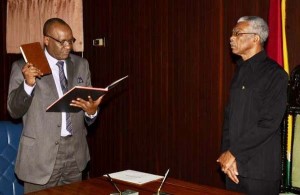 President David Granger, yesterday swearing in retired Army Colonel Joseph Harmon as the Minister of State of the Ministry of the Presidency, a new position.