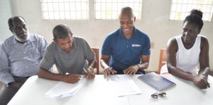 Proud moment! GFF NC Chairman Clinton Urling is all smiles after affixing his signature to the lease which was also signed by Eccles/Ramsburg NDC Chairman Mr. Saeed Khan (2nd left), GFF GS Richard Groden (left) and Ms. Abeena Moore Deputy PS, Ministry of Local Government.  