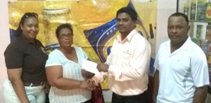 ANSA McAl Berbice Manager Mark Bhikhai hands over sponsorship cheque to BCB representative Angela Haniff in the presence of the Alicia Anderson, Marketing Assistant of the company and BCB selector Leslie Solomon.