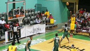 The Antiguans shoot over the Guyanese Monday night at the Caribbean Championships in Tortola, BVI. (www.caribbeanbasketball.com photo)