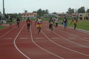 Compton Ceasar (lane 5) races to victory in the 100m Boys’ Youth Final yesterday at the National Track and Field Centre, Leonora.