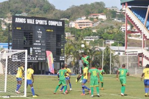 Golden Jaguar defender Jamaal Smith challenges SVG Goalie Winslow McDowall in the air.