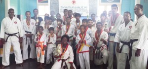 Students and Instructors pose with hardware won in a recent tournament.