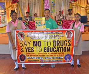 Edward B.Beharry Marketing Manager Satesh Singh poses with students after making presentations to the New Amsterdam Multilateral School.