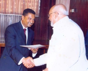 Justice Singh being congratulated by former President Donald Ramotar after his appointment to judgeship in October 2012