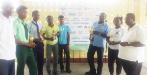 President of the Guyana Draughts Association, Jairam (extreme right) and tournament coordinator,  Paul Danjoo (extreme left), enjoy a photo op with the winners and runners up.  