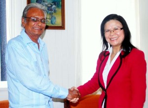 In the photo, Minister Roopnaraine greets the World Bank official.