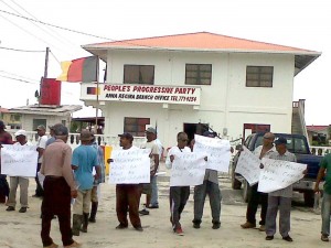 Rice farmers protesting at Anna Regina High Bridge, yesterday.