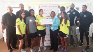 Ashely Rodrigues (left) of the Lady Jags received the cheque from Marketing Manager of Scotiabank Jennifer Cipriani in the presence of her team mates and officials of the GFF NC